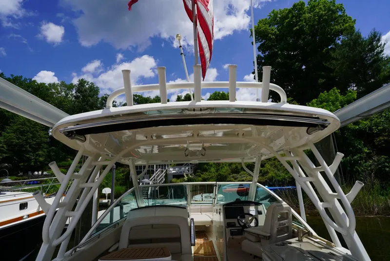 Slide: The Image of 2016 Boston Whaler 320 Vantage boat docked, view of cockpit and helm under blue sky. - 24