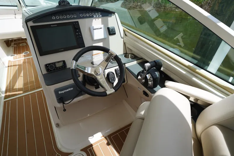 Slide: The Image of 2016 Boston Whaler 320 Vantage helm with Raymarine electronics and teak flooring. - 7