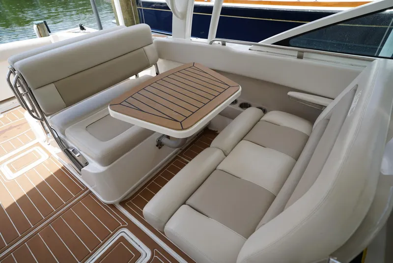 Slide: The Image of 2016 Boston Whaler 320 Vantage boat interior with seating and table. - 9