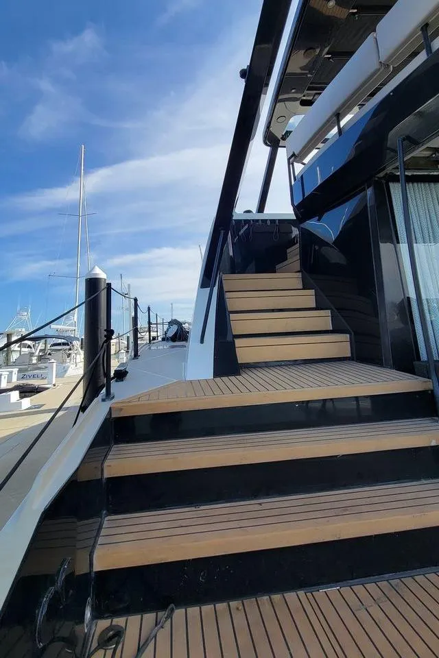 Slide: The Image of Luxury yacht Hussar WAVE 50, 2022 model, docked with wooden steps and sleek design. - 4