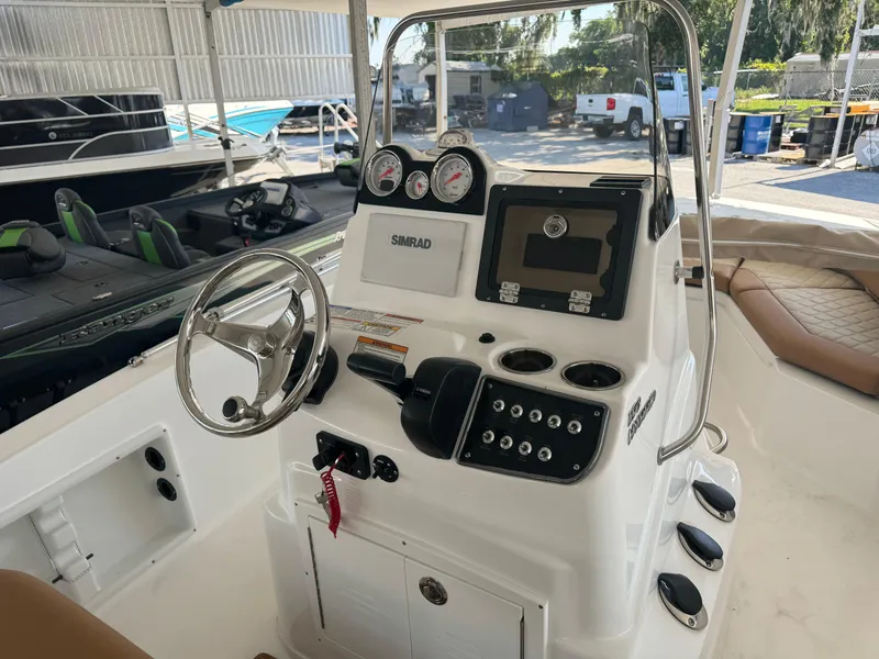 Slide: The Image of 2024 NauticStar 191 Hybrid boat console with steering wheel, gauges, and navigation system. - 12