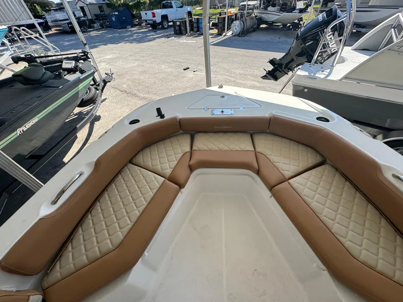 Slide: The Image of 2024 NauticStar 191 Hybrid boat with tan cushioned seating in the bow area. - 4