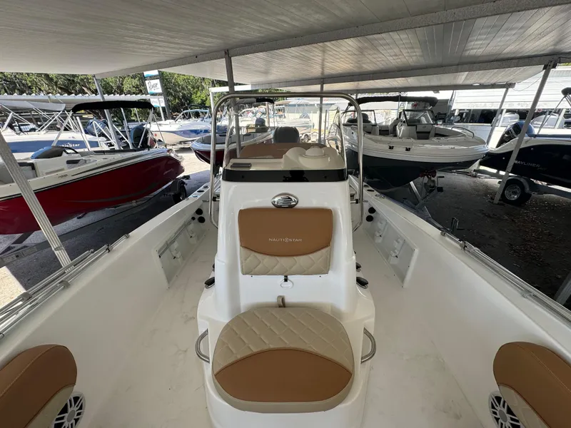 Slide: The Image of 2024 NauticStar 191 Hybrid boat interior at a dealership. - 5