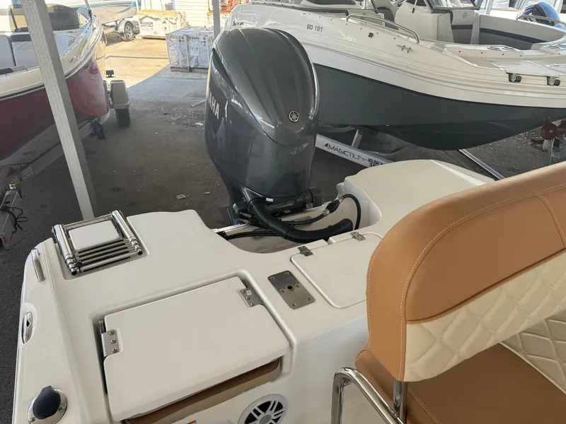 Slide: The Image of 2024 NauticStar 191 Hybrid boat with Yamaha outboard motor in showroom. - 9