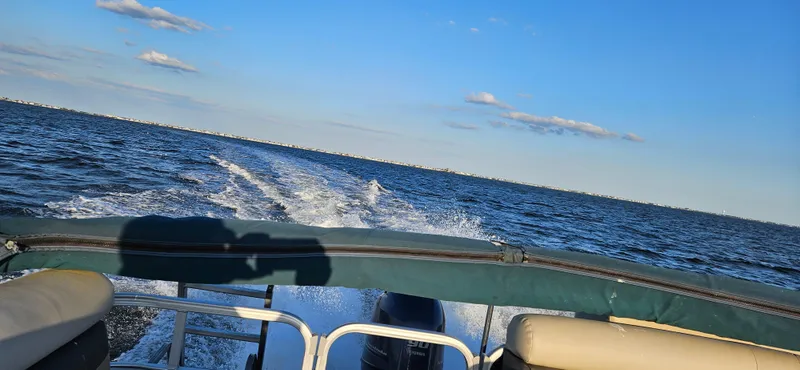 Slide: The Image of 2018 Sweetwater Sunrise 226 C pontoon boat cruising on open water. - 10