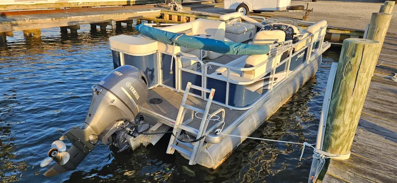 Slide: The Image of 2018 Sweetwater Sunrise 226 C pontoon boat docked at a marina. - 11