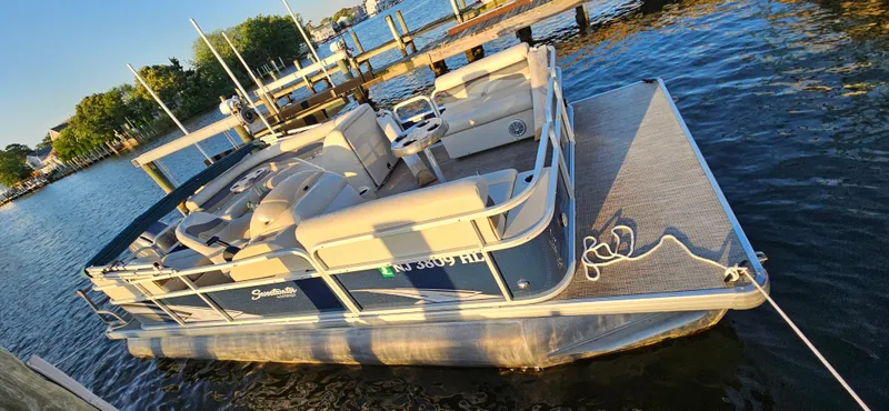 Slide: The Image of 2018 Sweetwater Sunrise 226 C pontoon boat docked on a sunny day. - 12