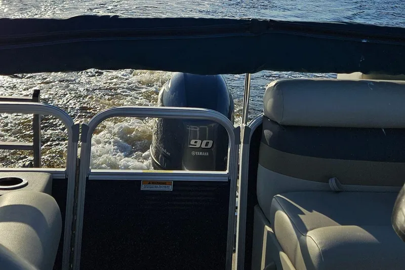 Slide: The Image of 2018 Sweetwater Sunrise 226 C pontoon boat with 90 HP outboard motor on water. - 17