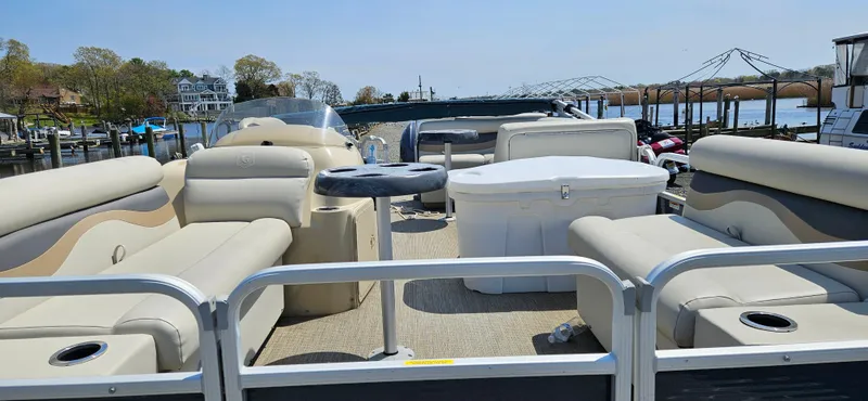Slide: The Image of 2018 Sweetwater Sunrise 226 C pontoon boat with beige seating and a spacious deck. - 3