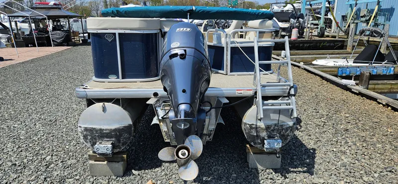 Slide: The Image of 2018 Sweetwater Sunrise 226 C pontoon boat docked on gravel. - 6