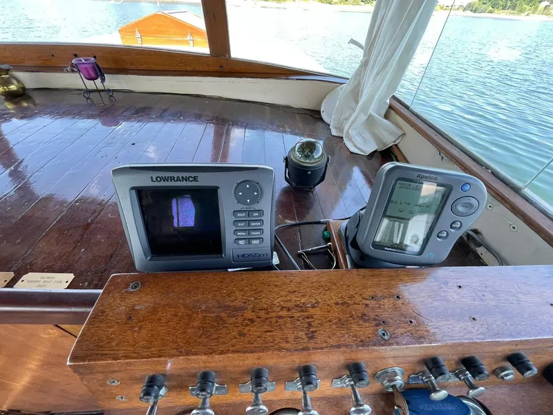 Slide: The Image of 1931 Jensen Cruiser dashboard with navigation equipment and wooden interior. - 11