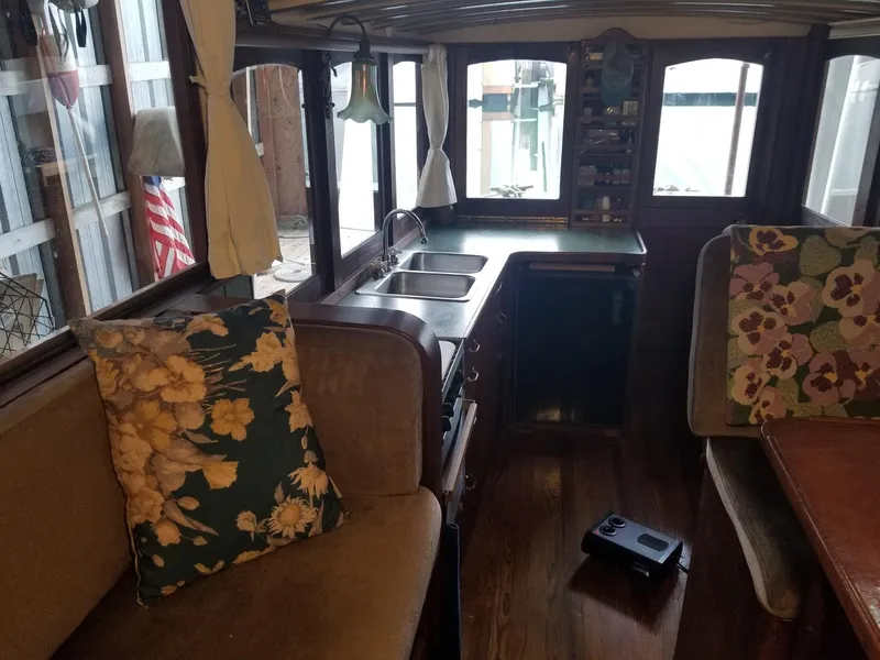 Slide: The Image of Interior of a 1931 Jensen Cruiser with vintage decor and floral cushions. - 2