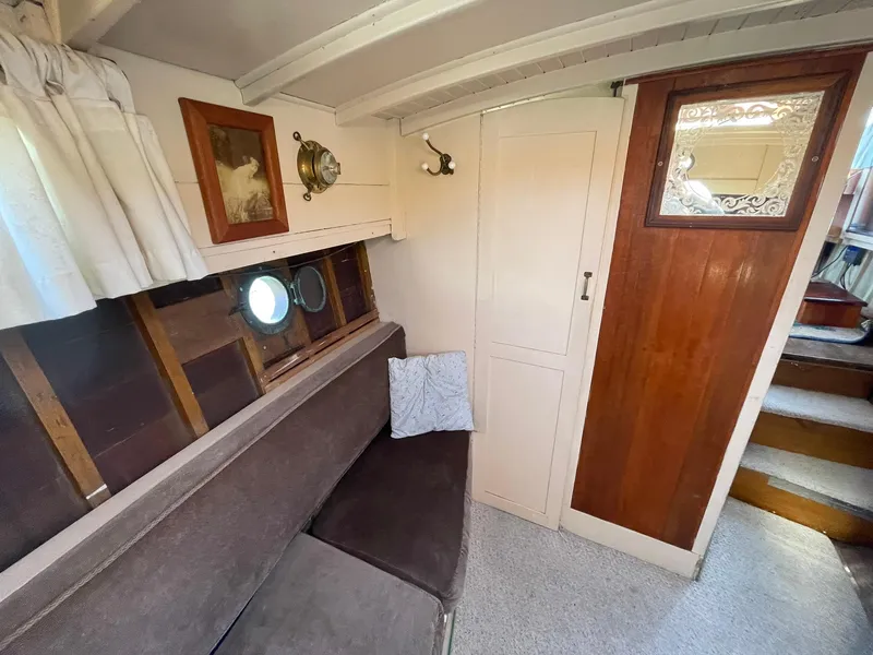 Slide: The Image of Interior of a 1931 Jensen Cruiser with vintage decor and wooden accents. - 23