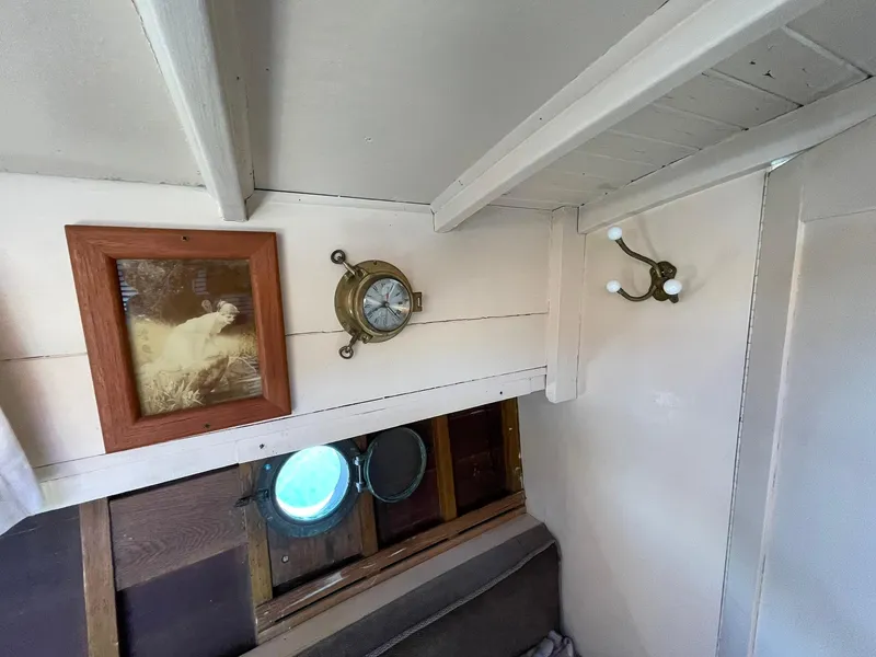Slide: The Image of Interior of a 1931 Jensen Cruiser with vintage decor and porthole window. - 24
