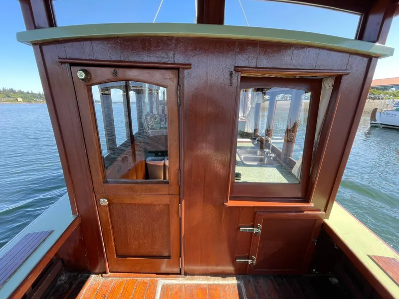 Slide: The Image of 1931 Jensen Cruiser with wooden cabin, docked by the water. - 27