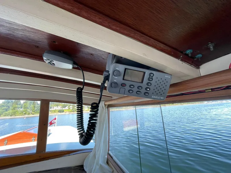Slide: The Image of Interior of a 1931 Jensen Cruiser with a mounted radio and lake view. - 30