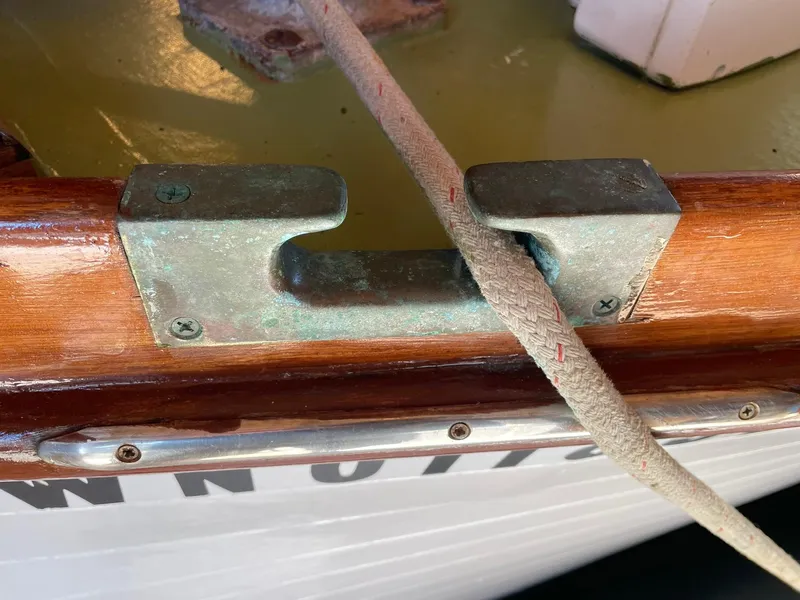 Slide: The Image of 1931 Jensen Cruiser with metal cleat and rope on wooden deck. - 43