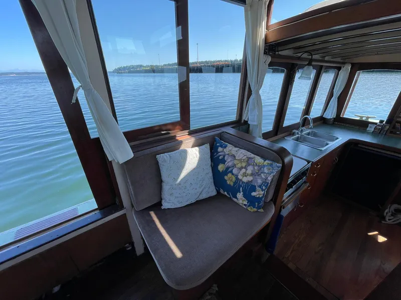 Slide: The Image of Interior of a 1931 Jensen Cruiser with cozy seating and scenic water view. - 5