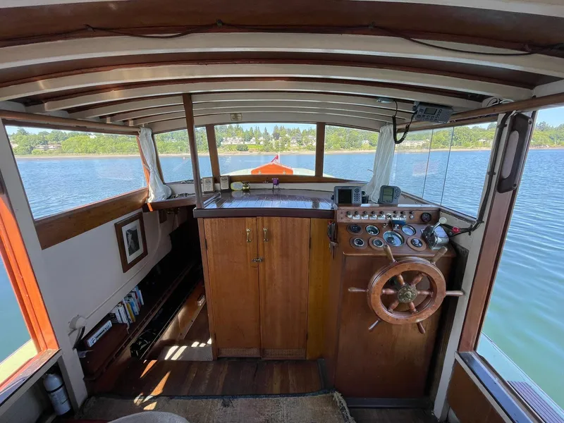 Slide: The Image of Interior of a 1931 Jensen Cruiser boat with wooden steering wheel and dashboard. - 7