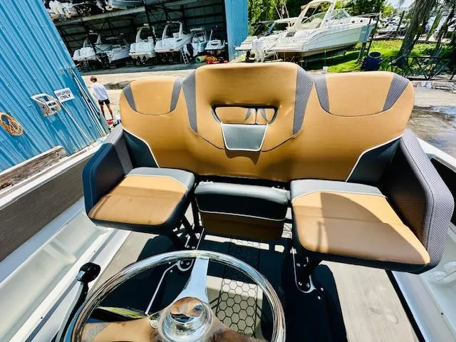Slide: The Image of 2023 Scarab 255 Open ID boat interior with tan and black seating. - 11