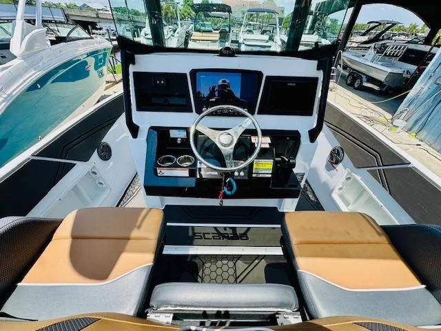 Slide: The Image of 2023 Scarab 255 Open ID boat dashboard with steering wheel and control panel. - 12