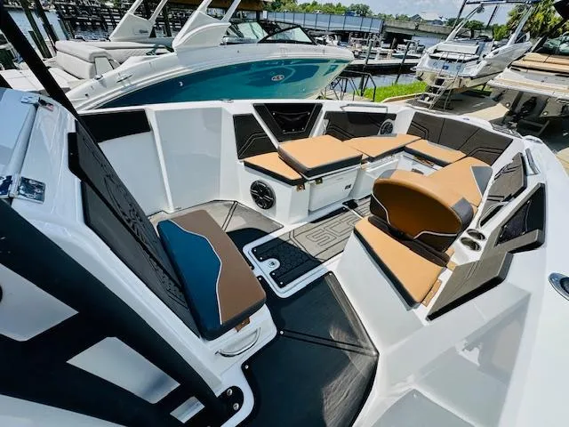 Slide: The Image of 2023 Scarab 255 Open ID boat interior with tan and black seating. - 14