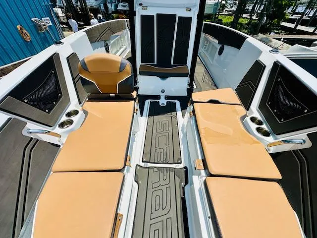 Slide: The Image of 2023 Scarab 255 Open ID boat interior with tan seating and black accents. - 17