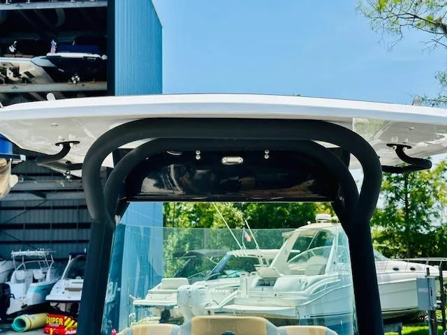 Slide: The Image of 2023 Scarab 255 Open ID boat with T-top in marina. - 19