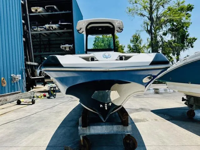 Slide: The Image of 2023 Scarab 255 Open ID boat on a trailer in a marina. - 5