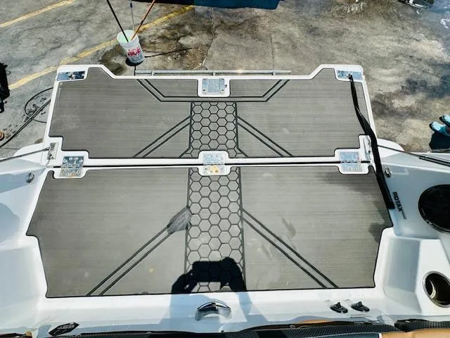 Slide: The Image of 2023 Scarab 255 Open ID boat deck with hexagonal pattern and storage compartments. - 7