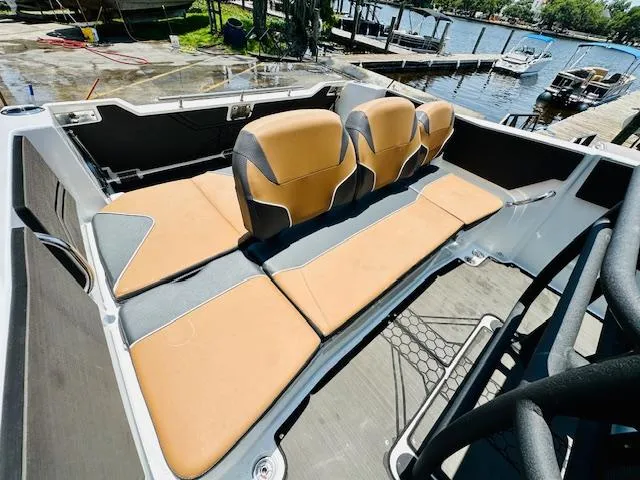 Slide: The Image of 2023 Scarab 255 Open ID boat interior with tan and gray seating. - 9
