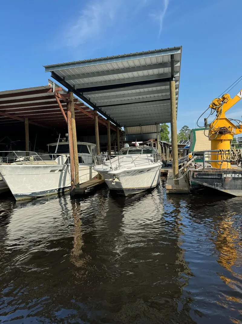 Slide: The Image of 1995 Sea Ray 500 docked under a covered marina. - 1
