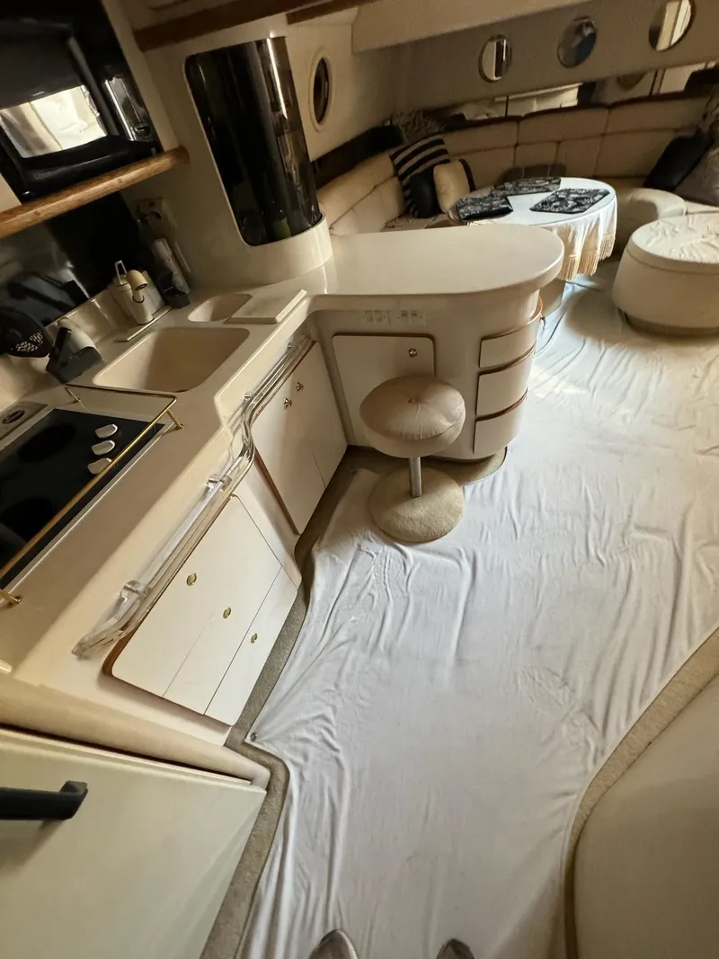 Slide: The Image of Interior of 1995 Sea Ray 500 yacht with kitchen and seating area. - 12