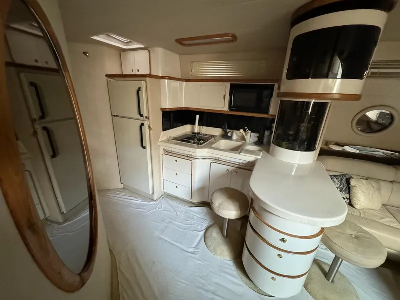 Slide: The Image of Interior of 1995 Sea Ray 500 yacht with kitchen and seating area. - 13