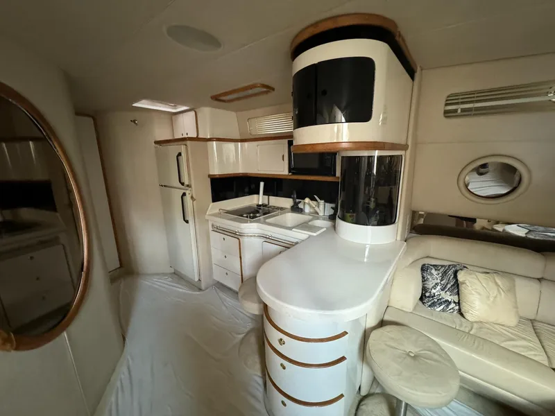 Slide: The Image of Luxurious 1995 Sea Ray 500 yacht interior with modern kitchen and cozy seating area. - 14