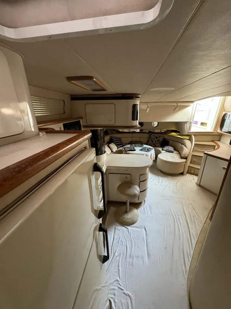 Slide: The Image of Interior of a 1995 Sea Ray 500 yacht, featuring a cozy seating area and modern design. - 16