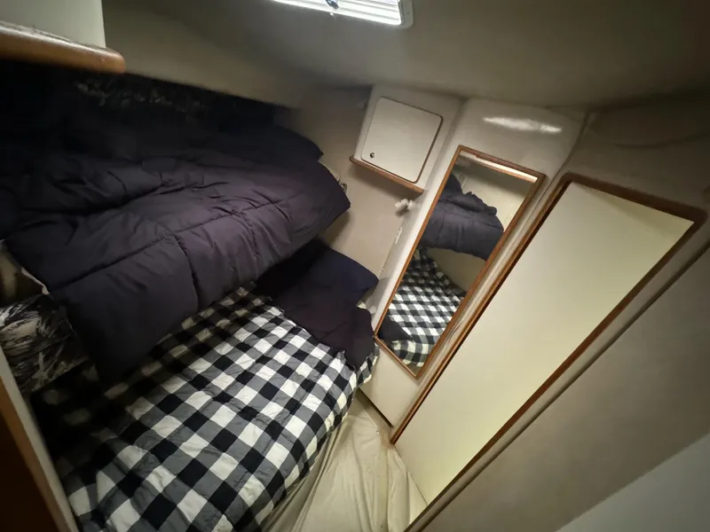 Slide: The Image of Cozy cabin interior of 1995 Sea Ray 500 yacht with bunk beds and mirror. - 18