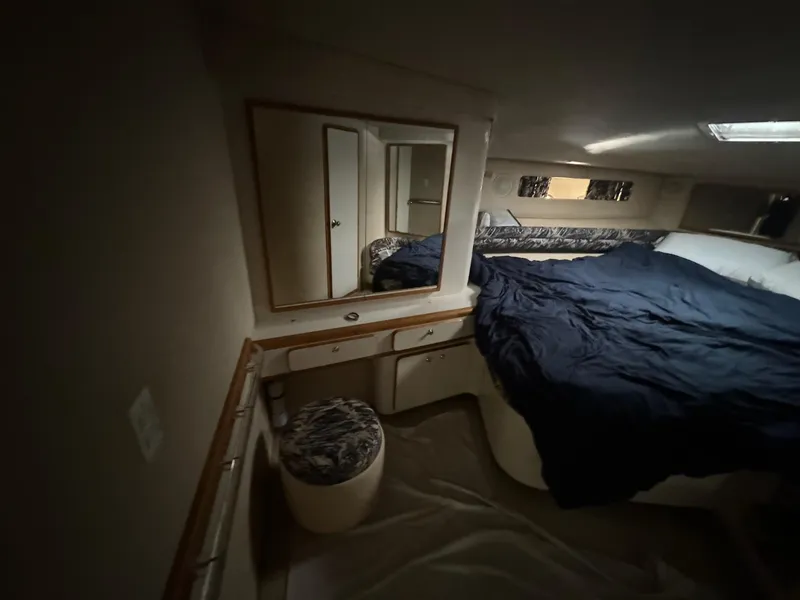 Slide: The Image of Cozy cabin interior of 1995 Sea Ray 500 yacht with bed and mirror. - 20