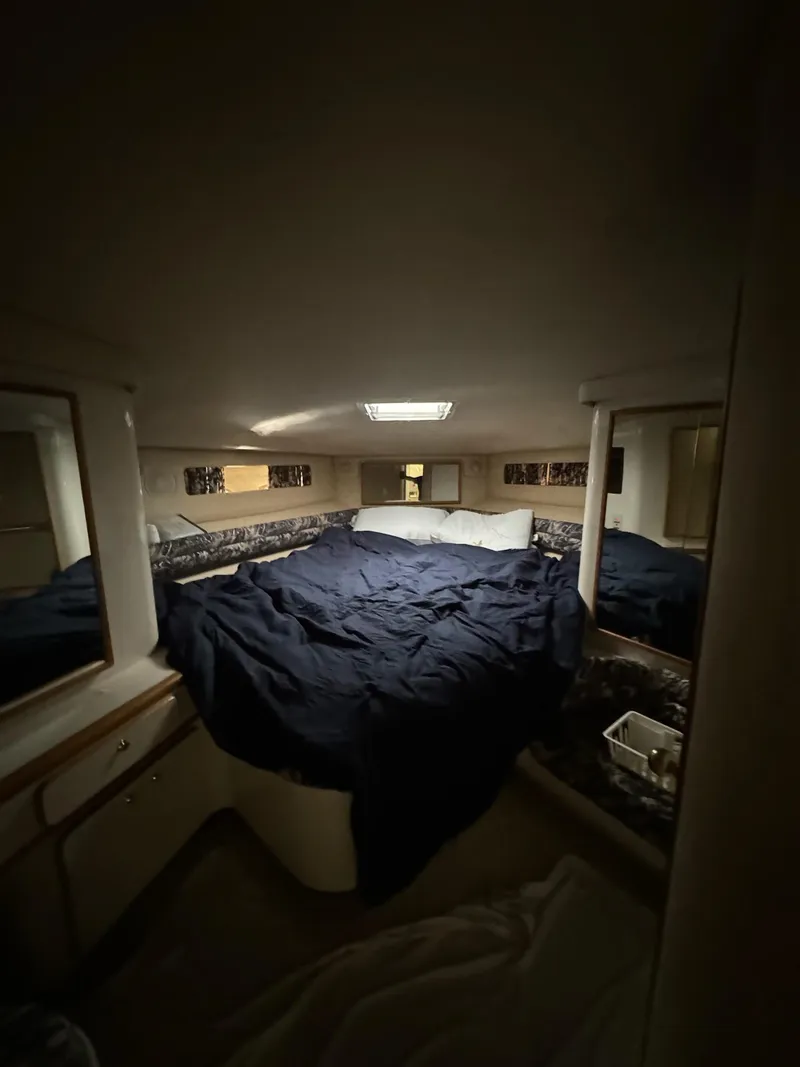 Slide: The Image of Cozy cabin interior of 1995 Sea Ray 500 yacht with bed and storage. - 21