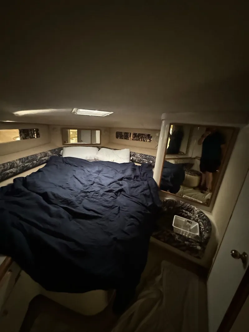 Slide: The Image of Cozy cabin interior of 1995 Sea Ray 500 yacht with bed and mirror. - 22