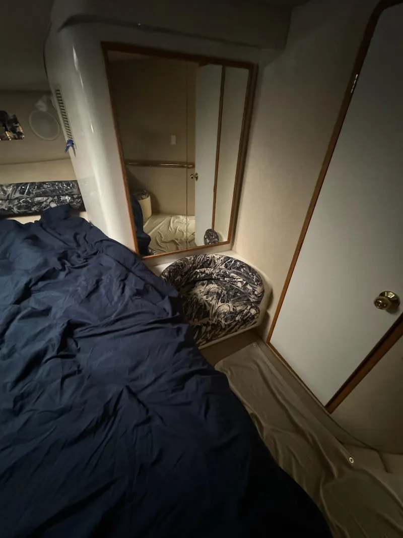 Slide: The Image of Interior cabin of a 1995 Sea Ray 500 yacht with bed and mirror. - 23