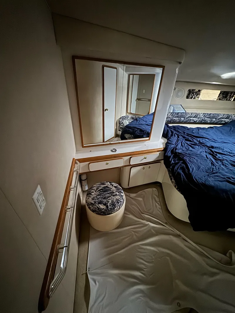 Slide: The Image of Interior of 1995 Sea Ray 500 yacht with bed, mirror, and seating area. - 24
