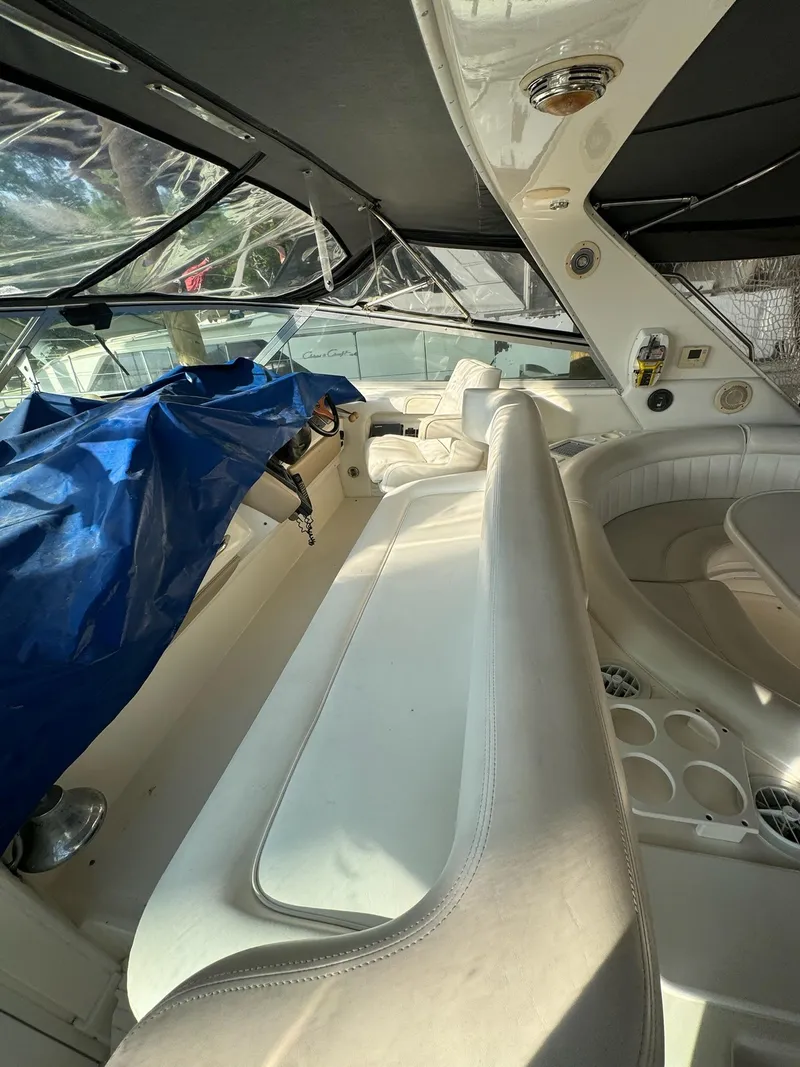 Slide: The Image of Interior of 1995 Sea Ray 500 yacht with white seating and covered controls. - 3