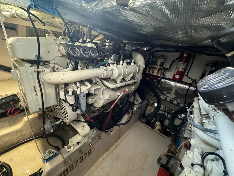 Slide: The Image of Engine room of a 1995 Sea Ray 500 yacht, showcasing mechanical components and wiring. - 30