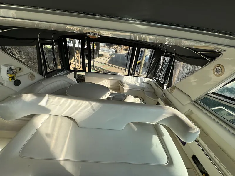 Slide: The Image of Interior of 1995 Sea Ray 500 yacht with white seating and panoramic windows. - 6
