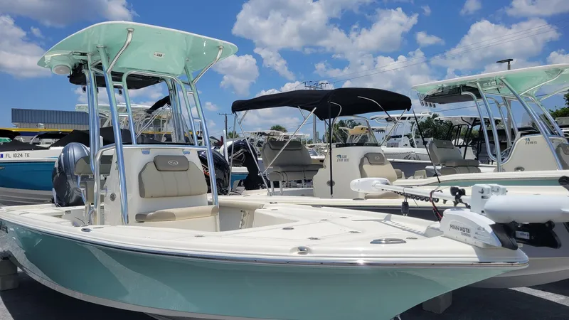 Slide: The Image of 2024 Key West 210 Bay Reef boat displayed outdoors under a sunny sky. - 0