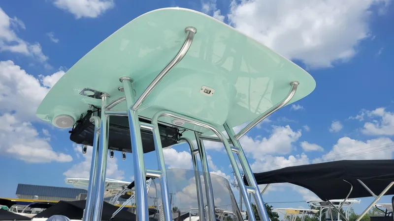 Slide: The Image of 2024 Key West 210 Bay Reef boat with T-top under a blue sky. - 2