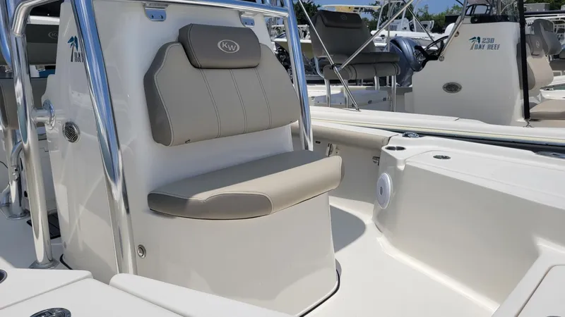 Slide: The Image of 2024 Key West 210 Bay Reef boat interior with cushioned seating and console. - 3