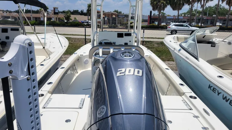 Slide: The Image of 2024 Key West 210 Bay Reef boat with Yamaha 200 engine, docked in a marina. - 5