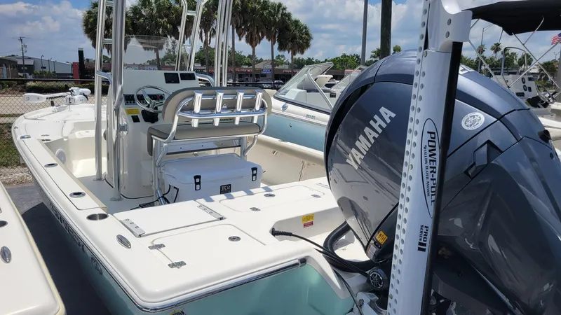 Slide: The Image of 2024 Key West 210 Bay Reef boat with Yamaha engine, docked under a sunny sky. - 6